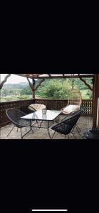 a table and chairs sitting on a porch with a view at Carlina House in Szczawnica