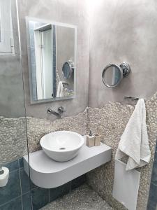 a bathroom with a sink and a mirror at Haraki Village in Haraki