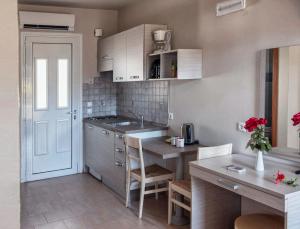 a small kitchen with a sink and a counter top at Haraki Village in Haraki