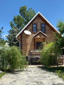 a wooden house with a white frisbee on it at Fairy Tale in Gabala