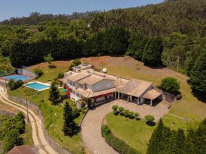 an aerial view of a house with a swimming pool at Quinta do Souto in Sever do Vouga