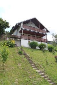 a house on a hill with stairs in front of it at Apartman Dunav in Aljmaš