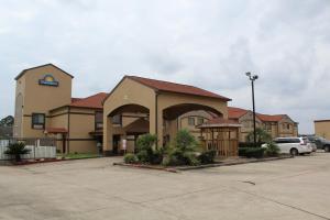 a large building with a parking lot in front of it at Days Inn by Wyndham Lumberton in Lumberton