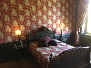 Château de Couin في Couin: غرفة نوم بسرير بجدار احمر