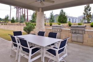 a white table and chairs on a patio at Candlewood Suites - Austin Airport, an IHG Hotel in Austin