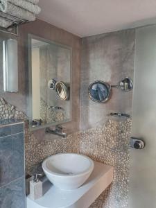 a bathroom with a sink and a mirror at Haraki Village in Haraki