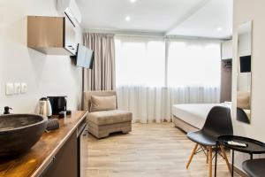 a hotel room with a sink and a bed at Raise The Heraklion Project in Heraklio Town