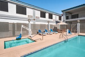 a swimming pool with lounge chairs and a swimming pool at Baymont by Wyndham Casa Grande in Casa Grande