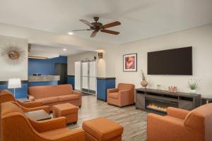 a living room with couches and a flat screen tv at Baymont by Wyndham Casa Grande in Casa Grande