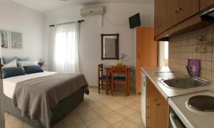 una cucina con un letto e un lavandino in una stanza di Volta Superior Studios ad Avlémonas