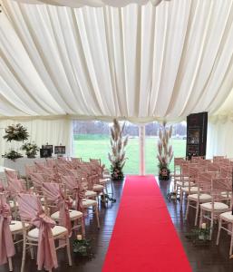 a large white tent with a red carpet and chairs at Silverwood Luxury Lodges & Bistro Barn in Perth