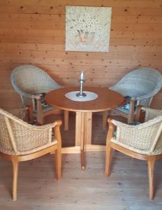 une table en bois avec deux chaises et un lavabo dans l'établissement Ferienhaus Gartenstraße, à Osten