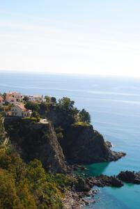 a house on a cliff overlooking the ocean at Appartamento vista mare in Copanello
