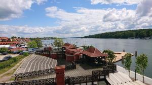 a building next to a body of water at Apartamenty Twoje Mikołajki in Mikołajki