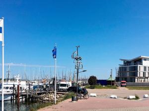 a man sitting on a bike next to a marina at 4 person holiday home in Wendtorf in Wendtorf