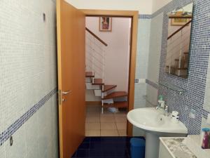 a bathroom with a sink and a toilet and a staircase at villa a mare in Senigallia +33 photos
