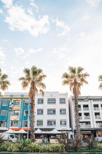 a group of palm trees in front of a building at Wake Up! Bondi Beach in Sydney