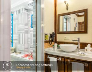 a bathroom with a sink and a mirror at Best Point Suites Old City - Best Group Hotels in Istanbul