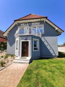 a house with a sign that reads villa nord at Willa Nord in Pustkowo