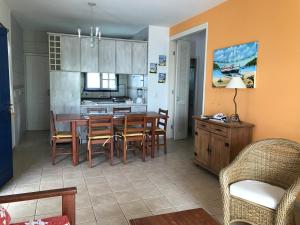 a kitchen and dining room with a table and chairs at Praias Brancas. Boa Vida in Florianópolis