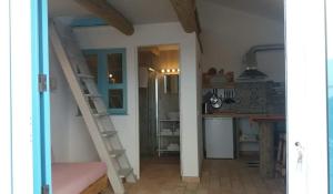 a room with a staircase leading to a kitchen at PuraVida Divehouse in Sagres