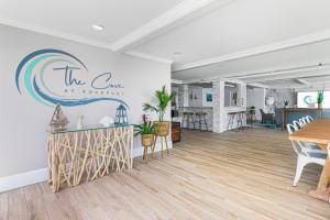 a dining room with a table and a sign on the wall at The Cove at Rockport in Rockport