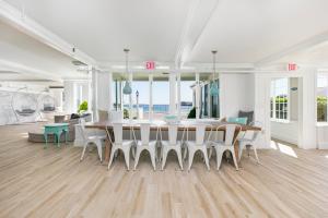 a white dining room with a table and chairs at The Cove at Rockport in Rockport +67 photos