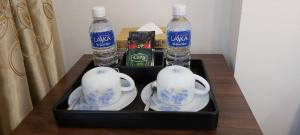 a tray with two bottles of water and tea sets on a table at Hanoi Endless Hotel in Hanoi