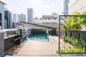 a swimming pool on the roof of a house at Citichic Sukhumvit 13 by Compass Hospitality in Bangkok