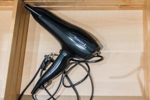 a black hair dryer sitting on top of a table at Felix Delhasse in Brussels