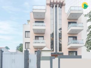 a pink building with a fence in front of it at Mavens House Gurgaon Behind Google Building NH 8 in Gurgaon