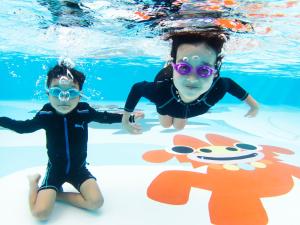 two young children are swimming in the water at Hotel Ocean (Kokusai-Dori) in Naha +37 photos