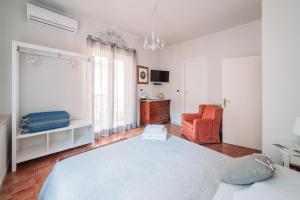 a bedroom with a large bed and a chair at B&B Greco Home in Taormina