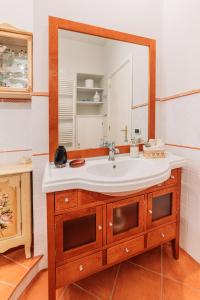 a bathroom with a sink and a mirror at B&B Greco Home in Taormina