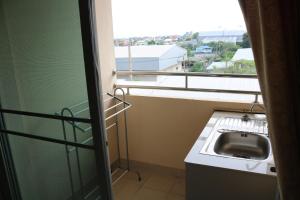 a bathroom with a sink and a window at Ladapan Mansion in Nonthaburi
