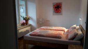 a bedroom with a bed with two pillows on it at Ferienwohnung Hagelstein in Bad Mergentheim