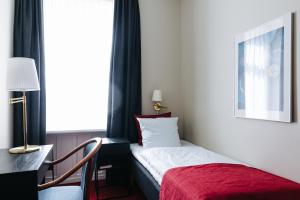 a hotel room with a bed and a window at City Hotel Nebo in Copenhagen
