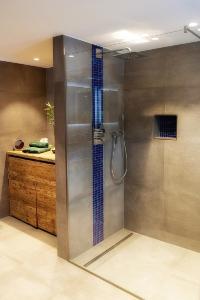 a shower with a glass door in a bathroom at Ferienwohnung Birkentalblick in Nesselwängle