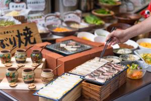 a person is preparing food at a buffet at Hotel Ocean (Kokusai-Dori) in Naha