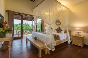 A bed or beds in a room at Villa Atap Padi by Nagisa Bali