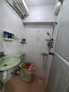 a bathroom with a toilet and a sink and a shower at Man Lai Wah Resort in Hong Kong