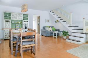 a living room with a staircase and a table at La Lujancita in Puerto del Carmen