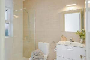 a bathroom with a shower and a toilet and a sink at La Lujancita in Puerto del Carmen +16 photos