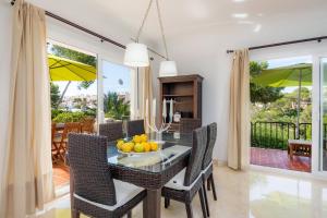 a dining room with a table with fruit on it at Na Pallissera 1 arriba in Cala Figuera