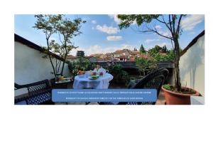 a person sitting at a table on a patio at B&B Vicenza San Rocco in Vicenza