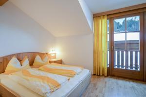 1 dormitorio con cama y ventana grande en Wieserhof - Apartment Benjamin, en Valles
