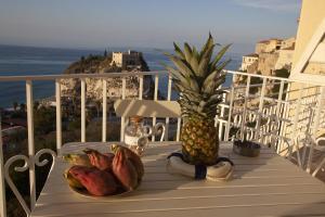 a pineapple sitting on top of a table on a balcony at Le Tolde del Corallone in Tropea