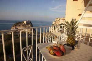 a pineapple sitting on a table on a balcony at Le Tolde del Corallone in Tropea