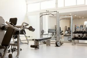 a gym with cardio equipment and mirrors in a room at Sunprime Ayia Napa Suites - Adults Only in Ayia Napa