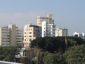 a group of tall buildings in a city at Delphi Hotel in Nicosia +17 photos